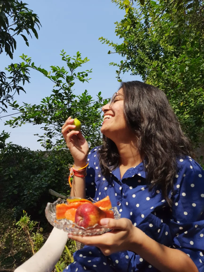 Annanya enjoying her breakfast while basking in the sunlight