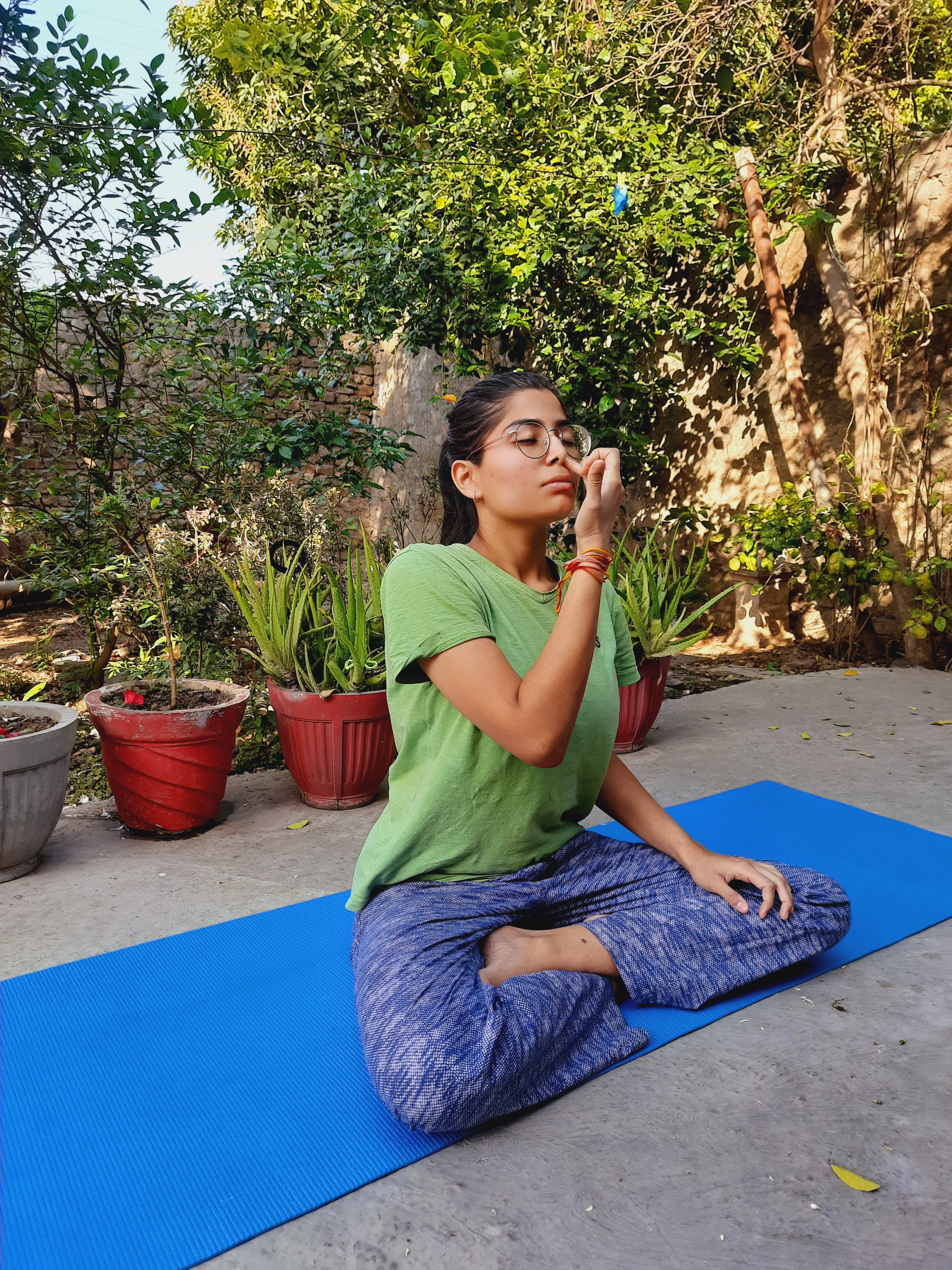 Annanya practicing pranayama in her home backyard