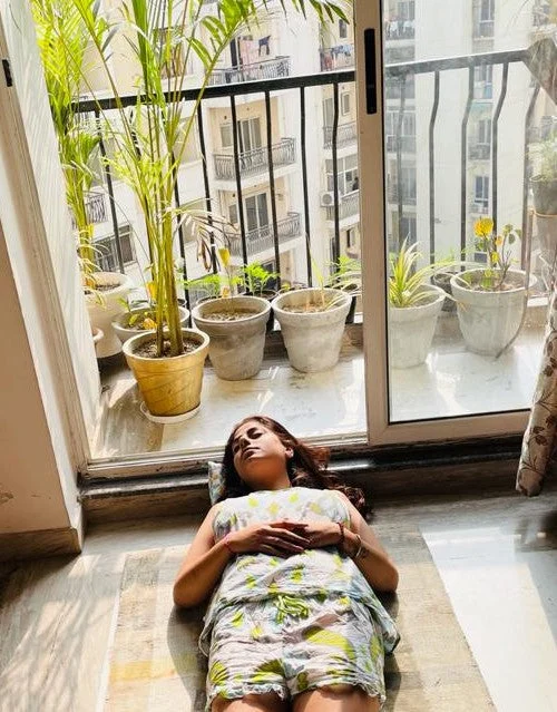 Neha sunbathing in her balcony