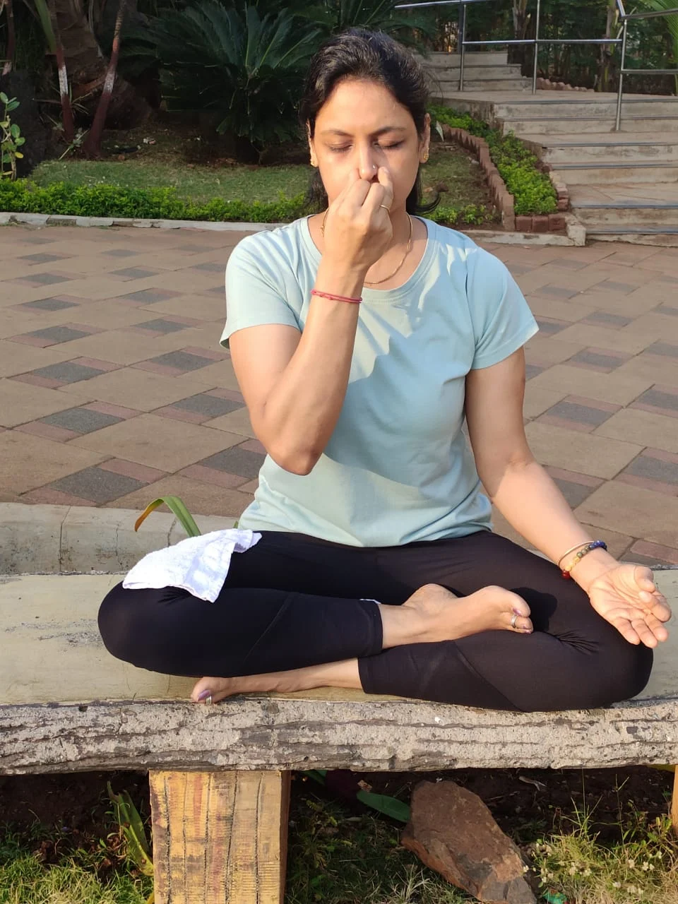 Neha ji practicing pranayama out in a park